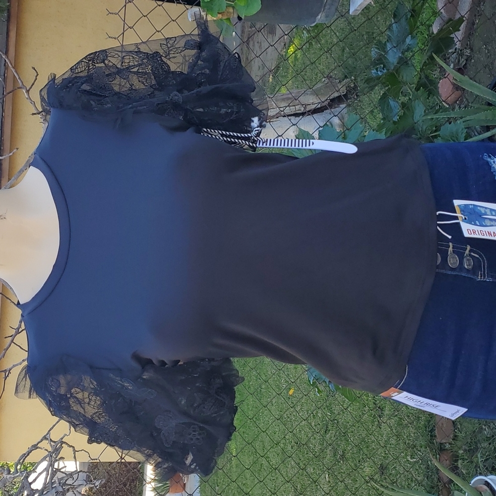 Cute black top with butterflies on the sleeve. The sleeve is like a mesh materia